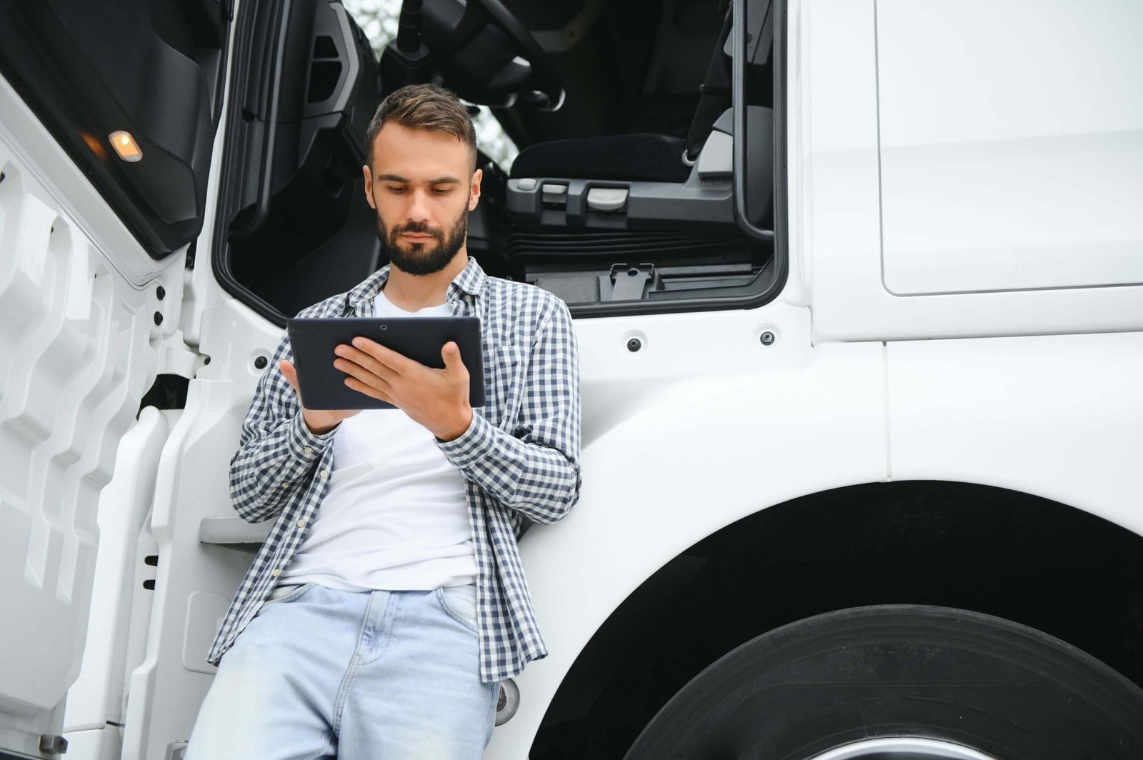How technology is transforming the trucking industry Men Driver Near Lorry Truck Man Owner Truck Driver HE5Z5MC Scaled 1